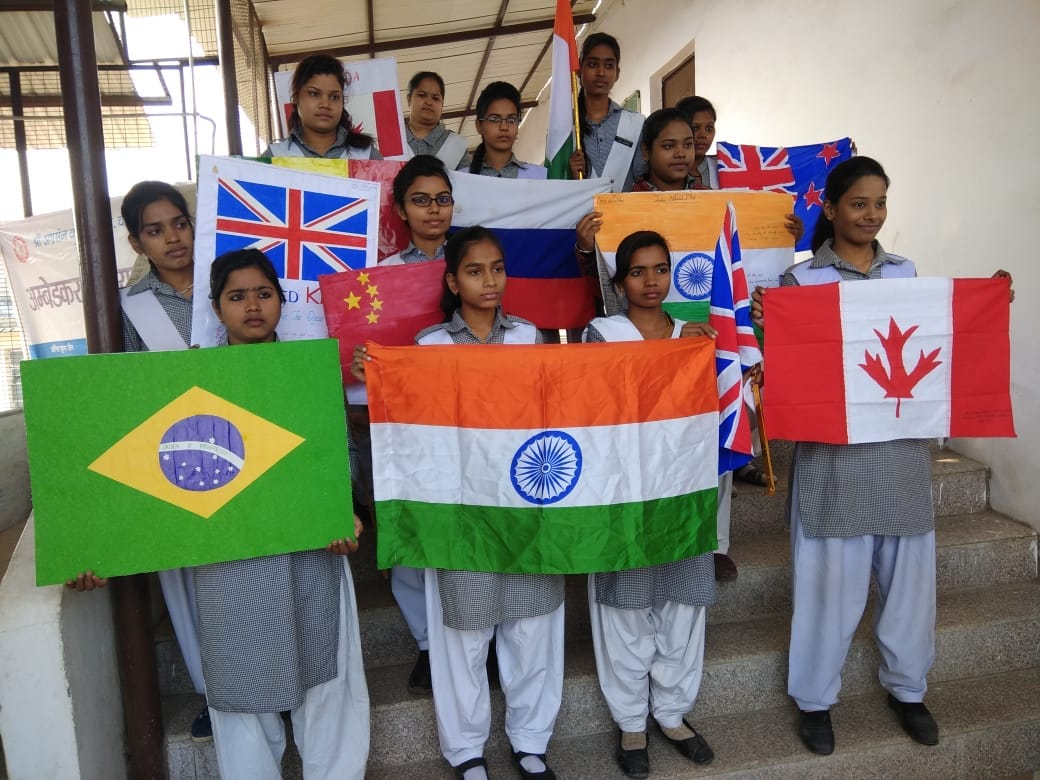 Student girls made 40 country flags with hands for migrants honour