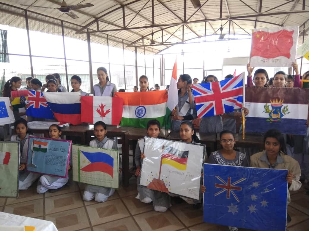 Student girls made 40 country flags with hands for migrants honour