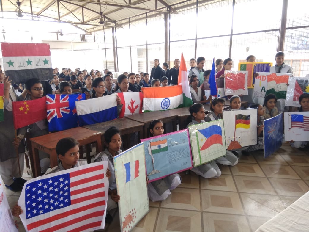 Student girls made 40 country flags with hands for migrants honour