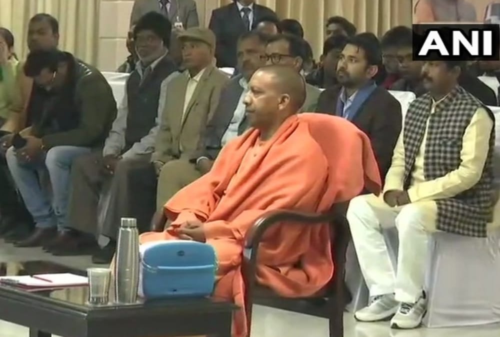 Yogi adityanath listening to man ki baat.