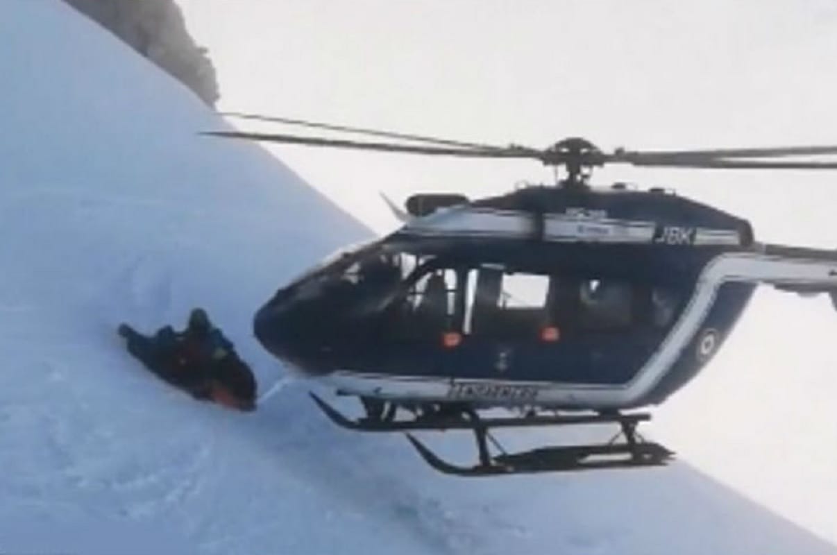 Pilot balances nose of helicopter on a slope in a rescue on French Alps