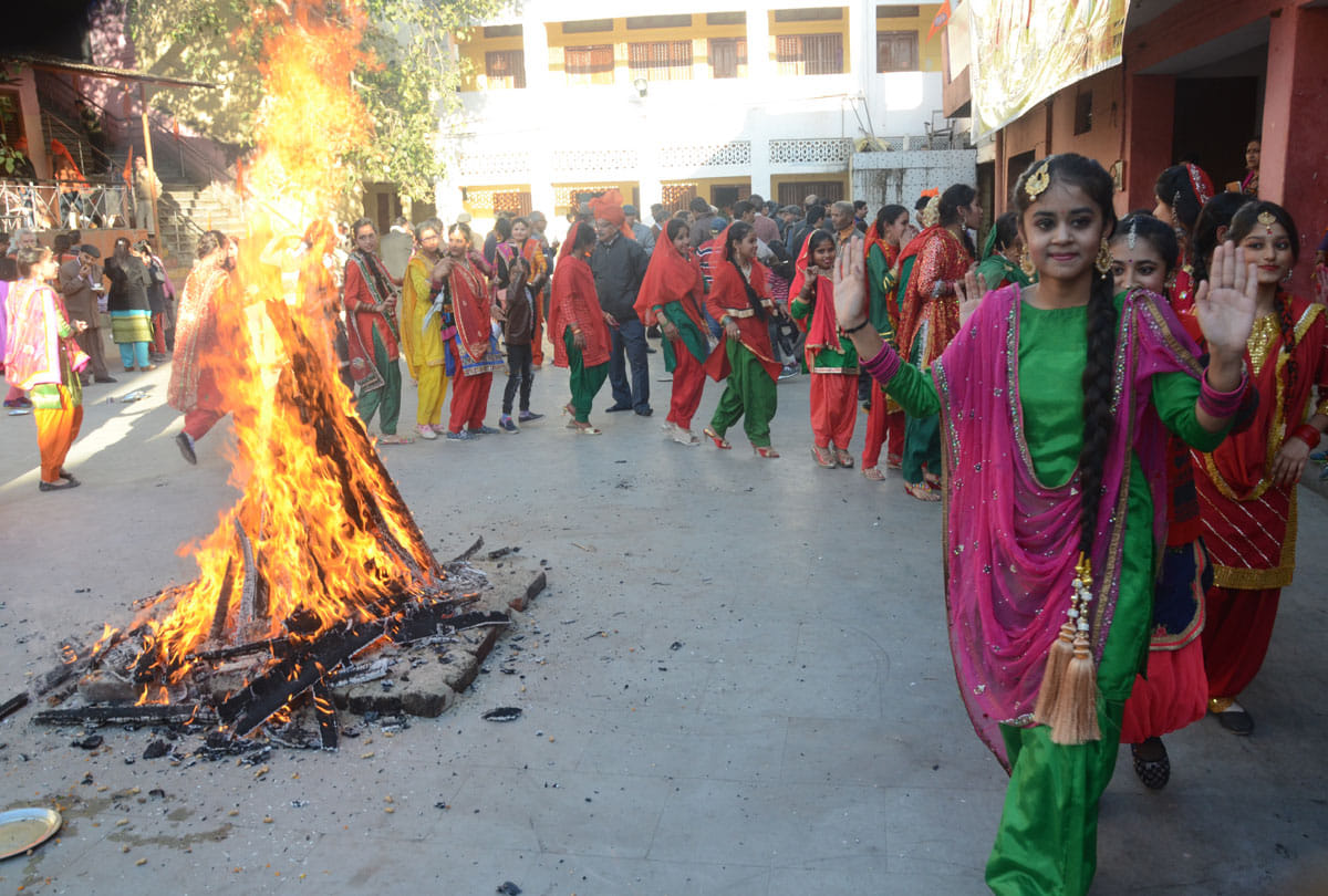 people Celebrating Lohri with fire dancing and singing