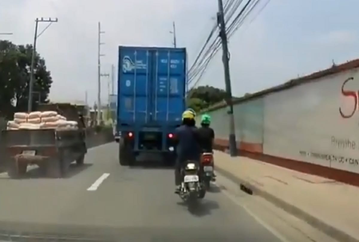 viral video : biker survives getting his head run over by truck