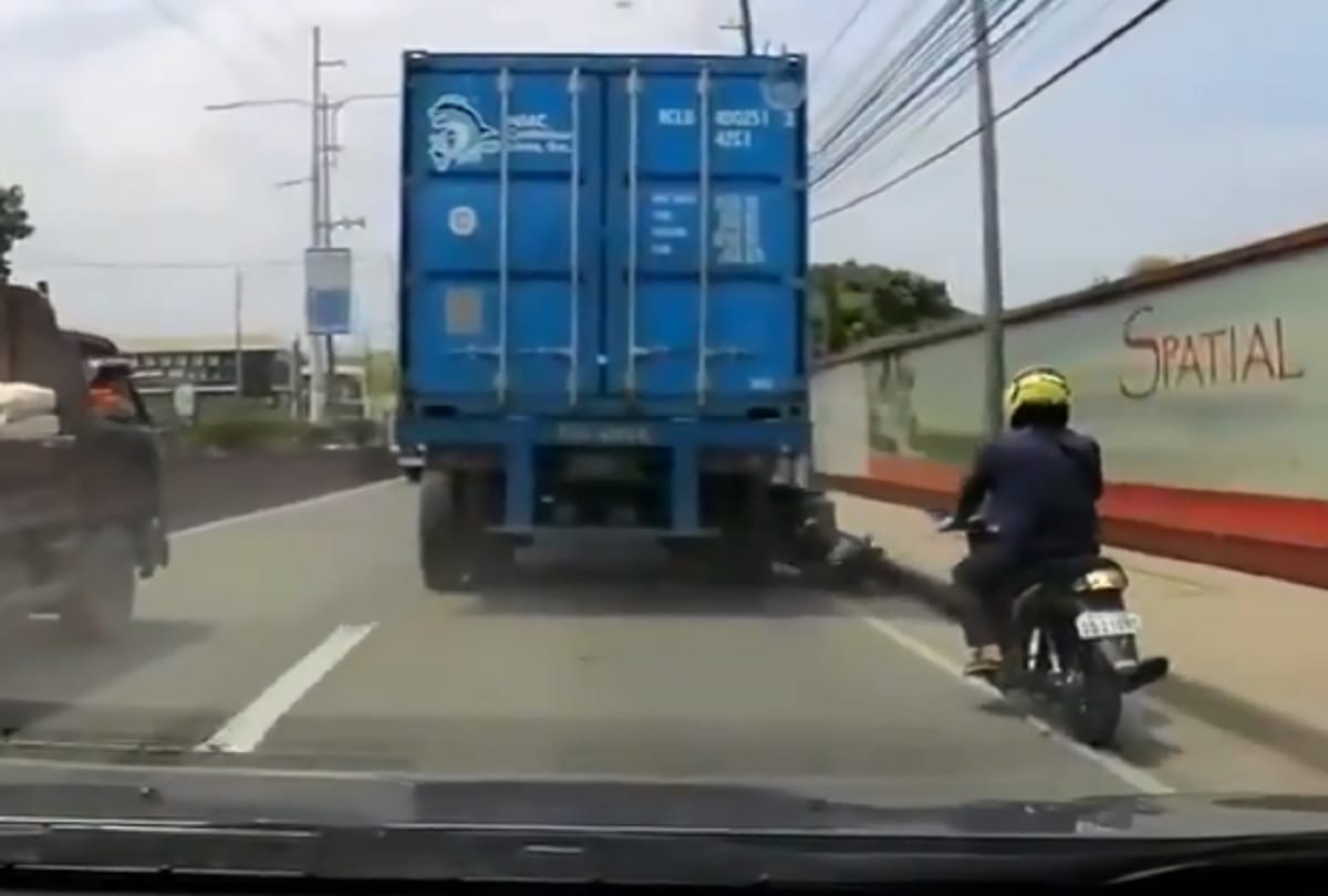 viral video : biker survives getting his head run over by truck