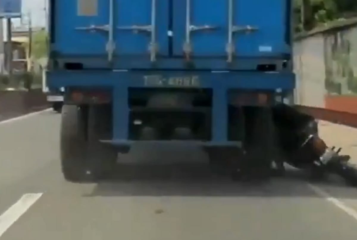 viral video : biker survives getting his head run over by truck