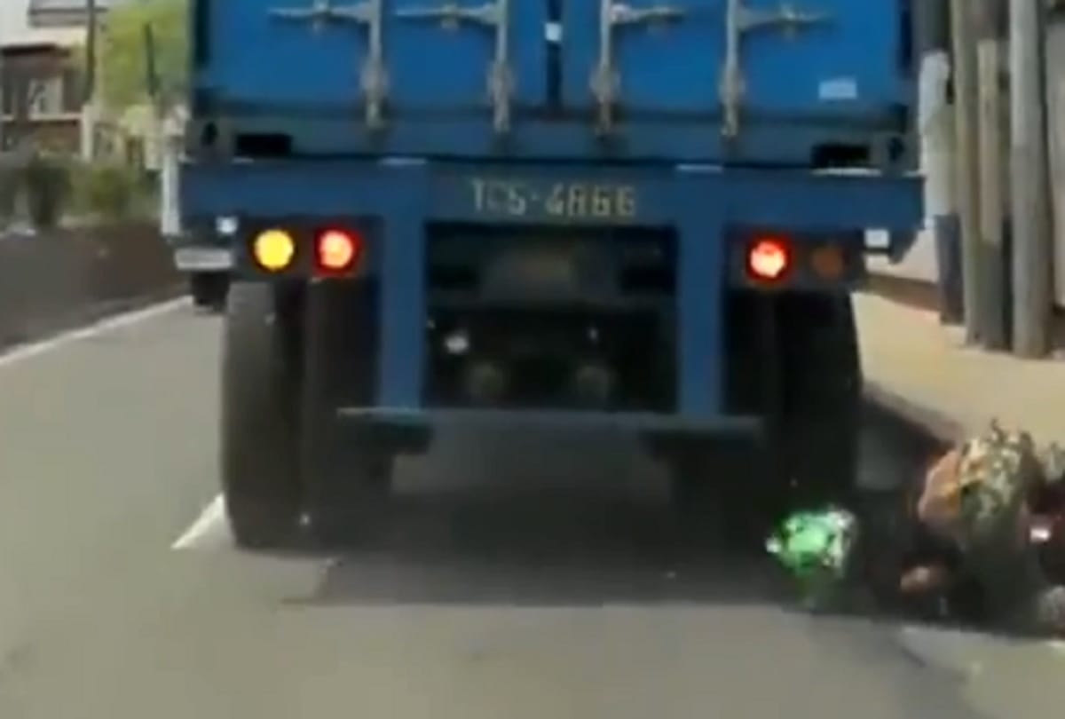 viral video : biker survives getting his head run over by truck