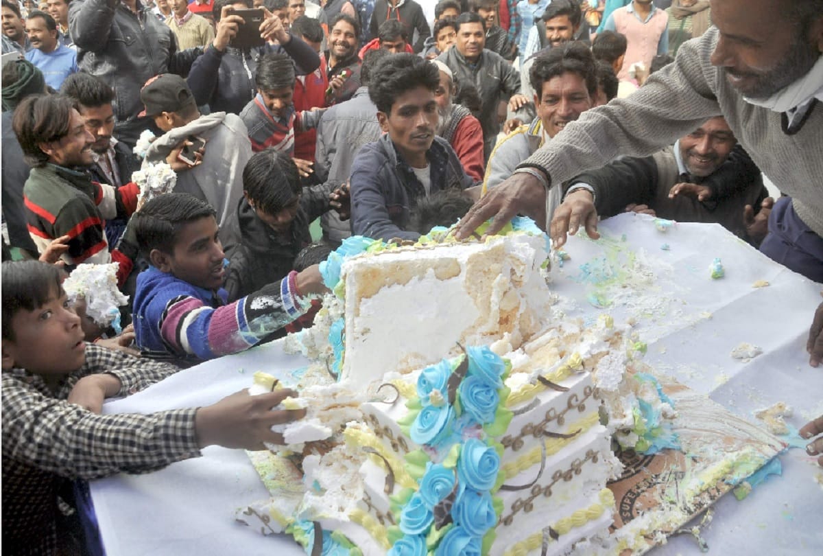 People loot cake during an event in Amroha on BSP chief Mayawati 63rd birthday