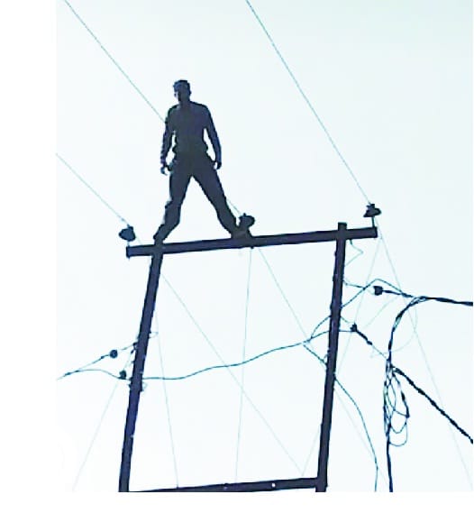 man on transformer pole