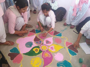girls make rangoli and discuss nss aim