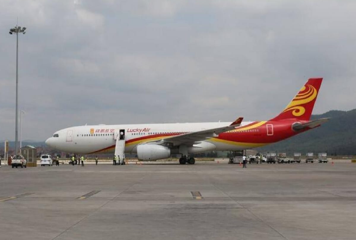 chinese man throws coins into airplane engine for good luck