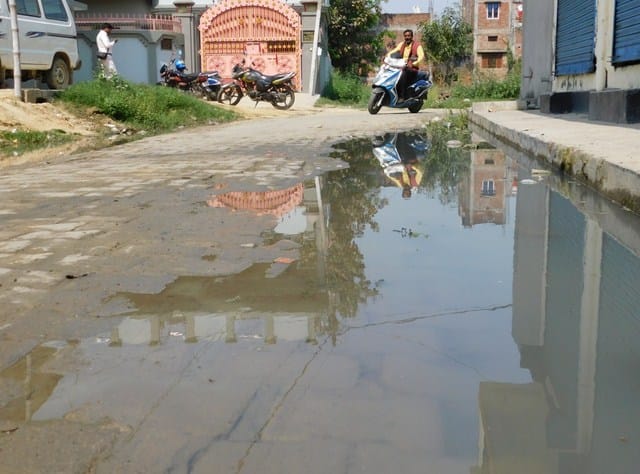 Gutter jam, dirty water people bothered on the road