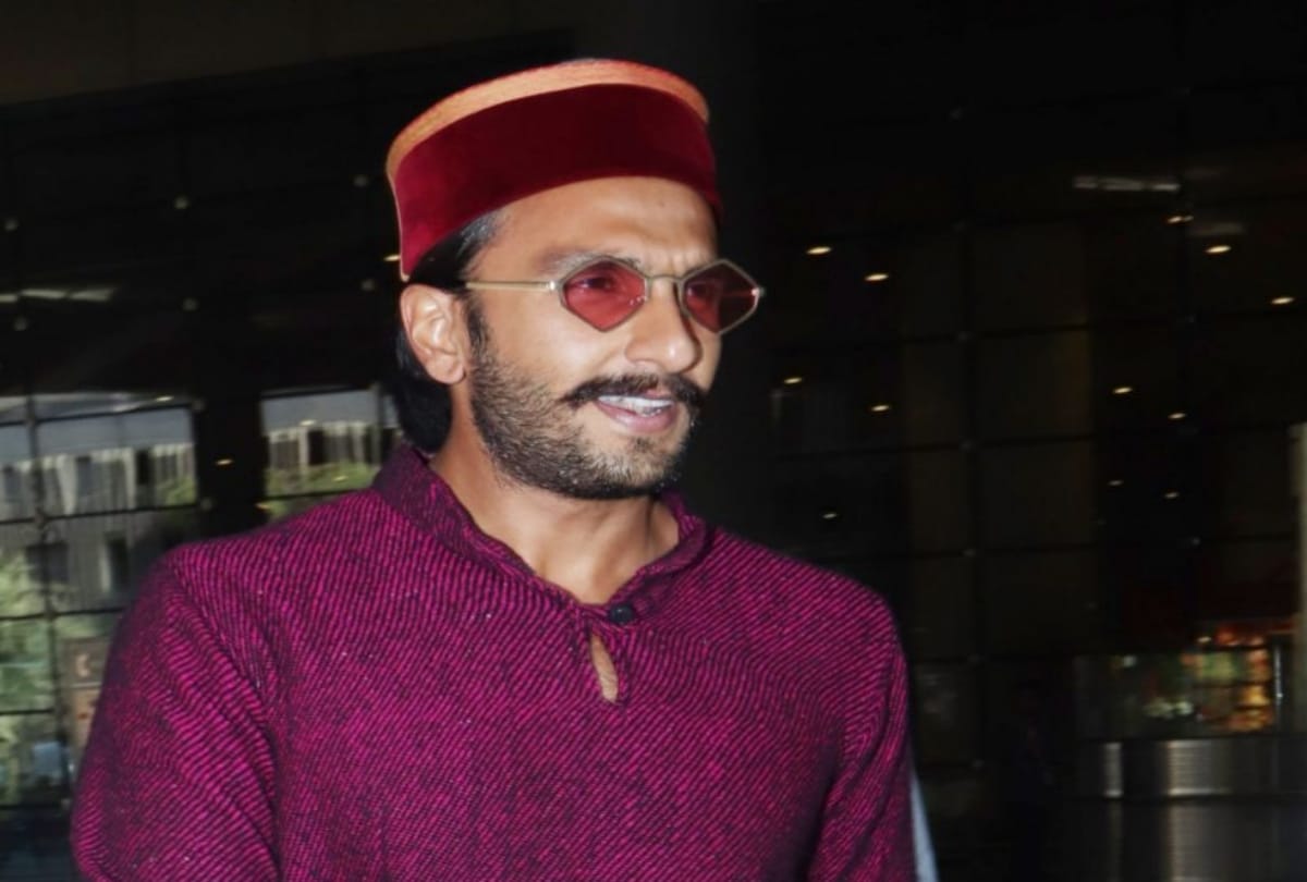 Ranveer Singh on his knees offering a rose to an old lady in a wheelchair in london
