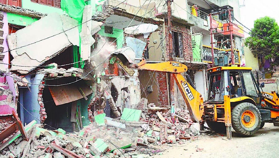 Riding on JCB being removed from encroachment