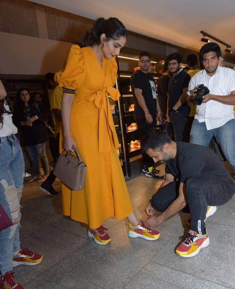 sonam kapooor husband anand ahuja tie her shoe lace at store launch event