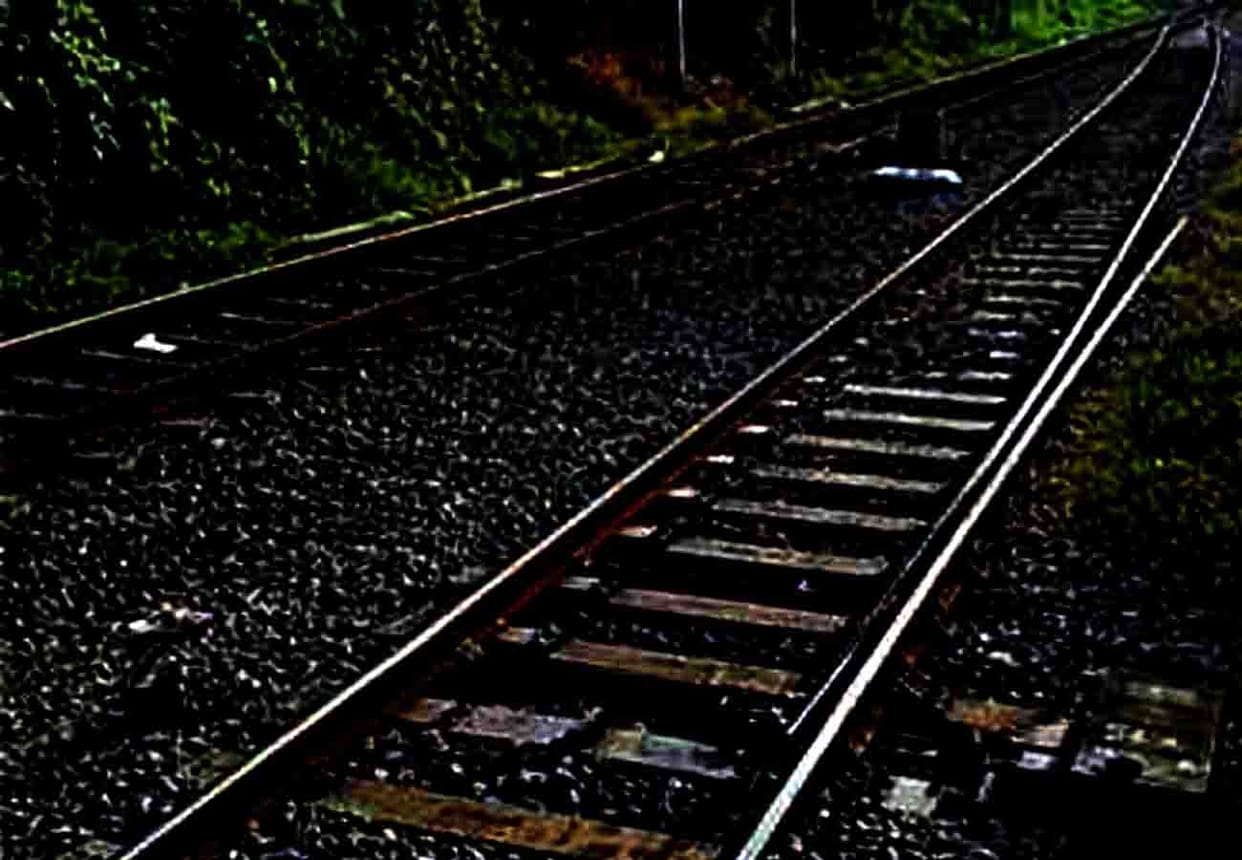 woman lying on the railway track with a six year old son