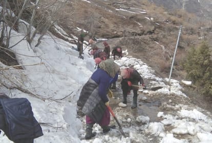 women clear snow on 2.5 kilometer road in lahaul spiti himachal Pradesh