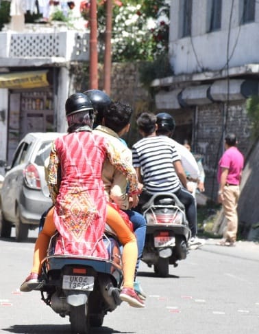 Youngsters running two wheelers without helmets