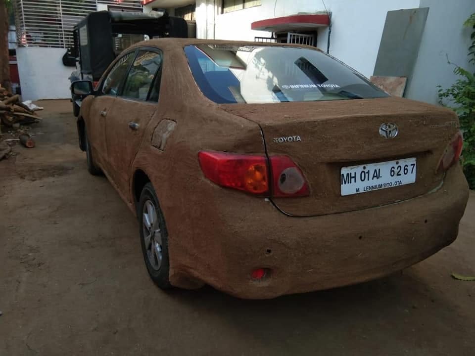 Toyota Corolla Altis plastered with dung and Jaguar XE roof covered with thatched
