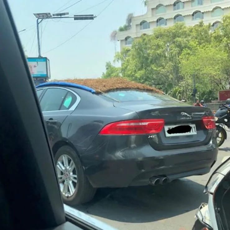 Toyota Corolla Altis plastered with dung and Jaguar XE roof covered with thatched