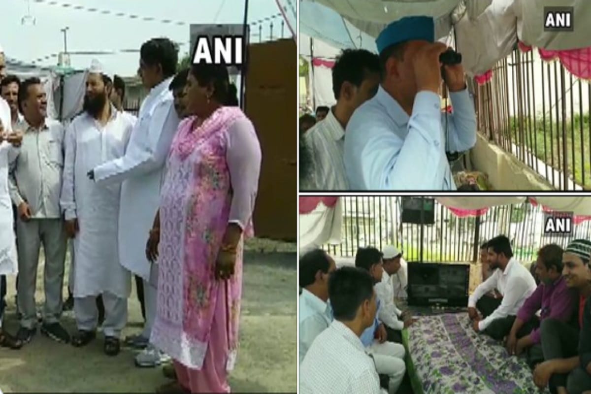 Supporters of BSP SP RLD alliance candidate Yakoob Qureshi camp outside a EVM strong room