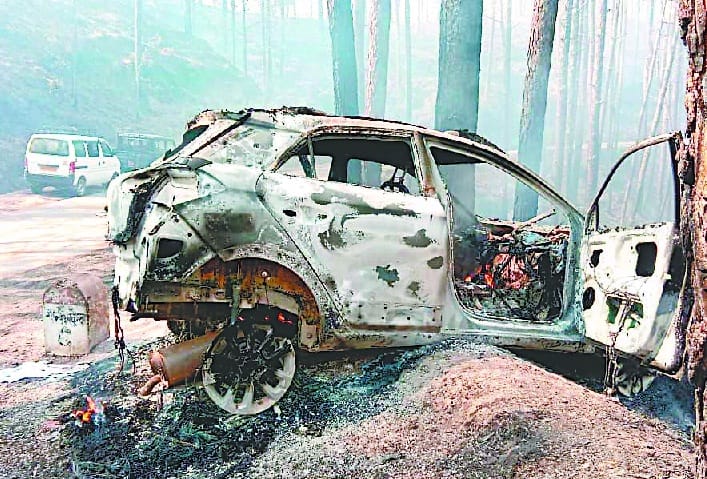 Burnt car on the highway from the forest fire