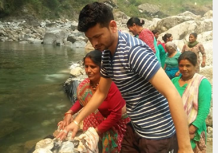 Women in Kapkot repair the canal of the Shramadan tax