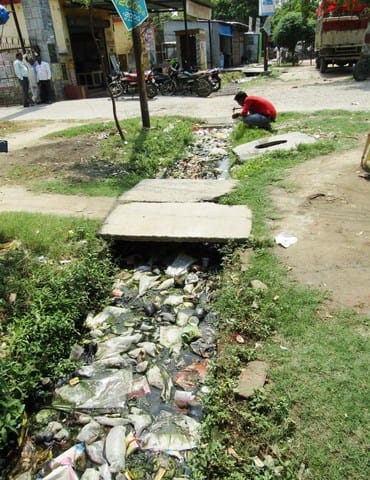 Rainy season close, roads damaged, city gutter jams