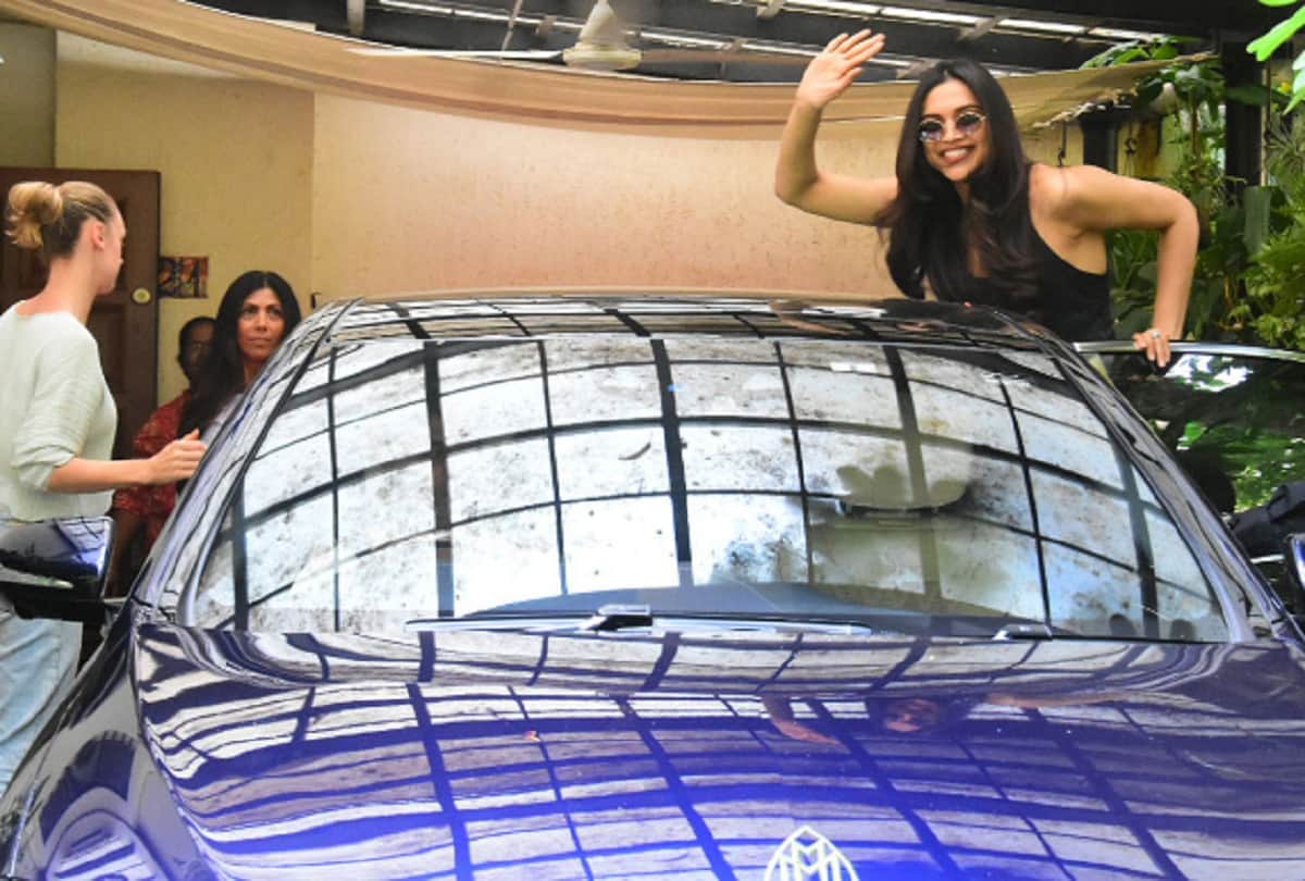 Deepika Padukone trying to come up on car bonnet and gives smiling pictures to media