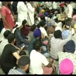 People hold protest in Mukherjee Nagar police station after the incident of auto driver thrashed