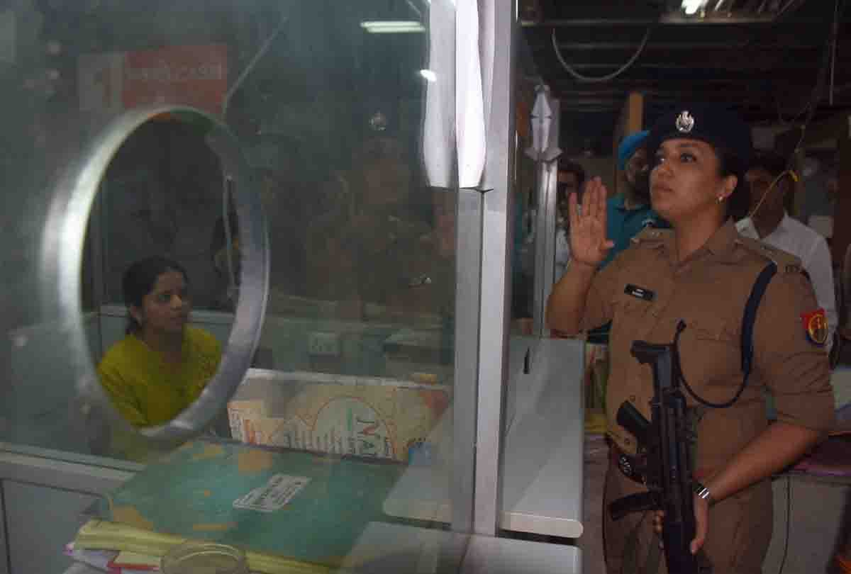 woman in police uniform with gun reached in bank