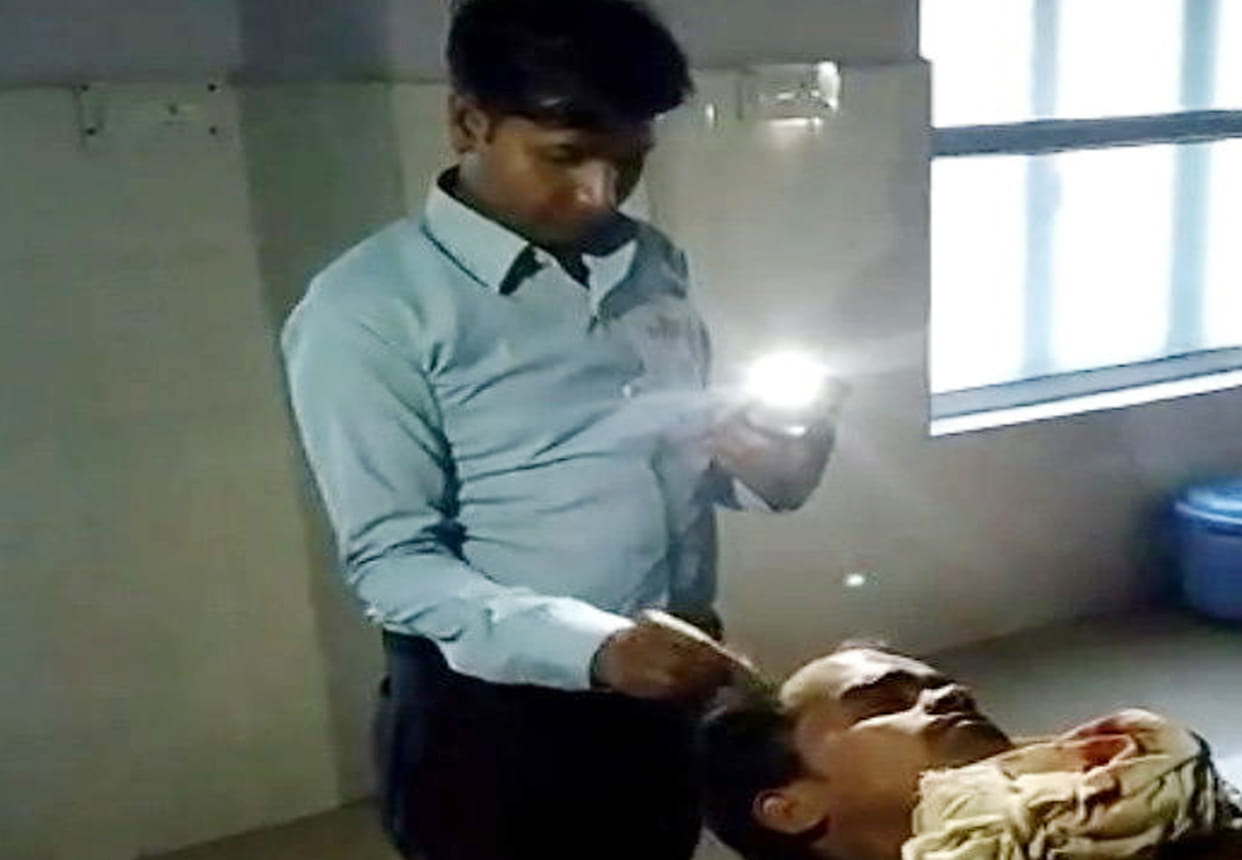 doctor stitch wounds in mobile light at etawah