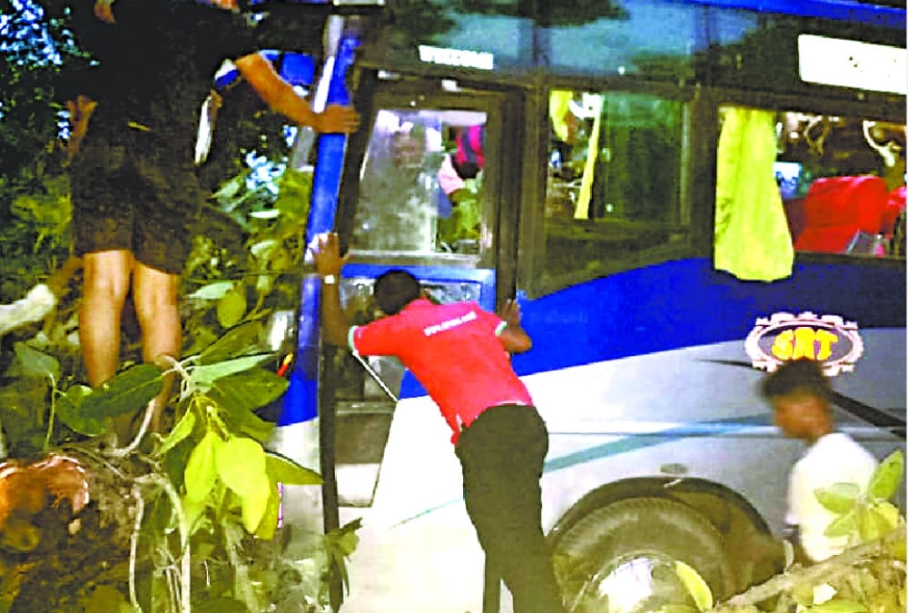 A big tree falls down on a tourist bus in Sultanpur.