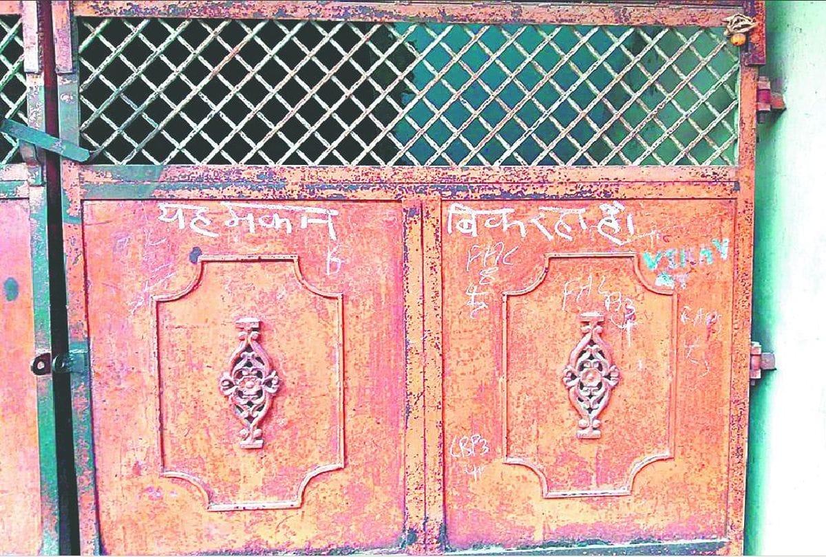 people pasted sale of houses poster in agra
