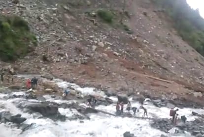 village crossing flooded nala bharmour chamba himachal pradesh