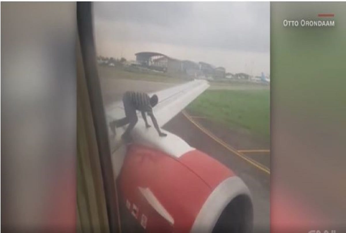 man jumping on flight wing in murtala muhammed airport