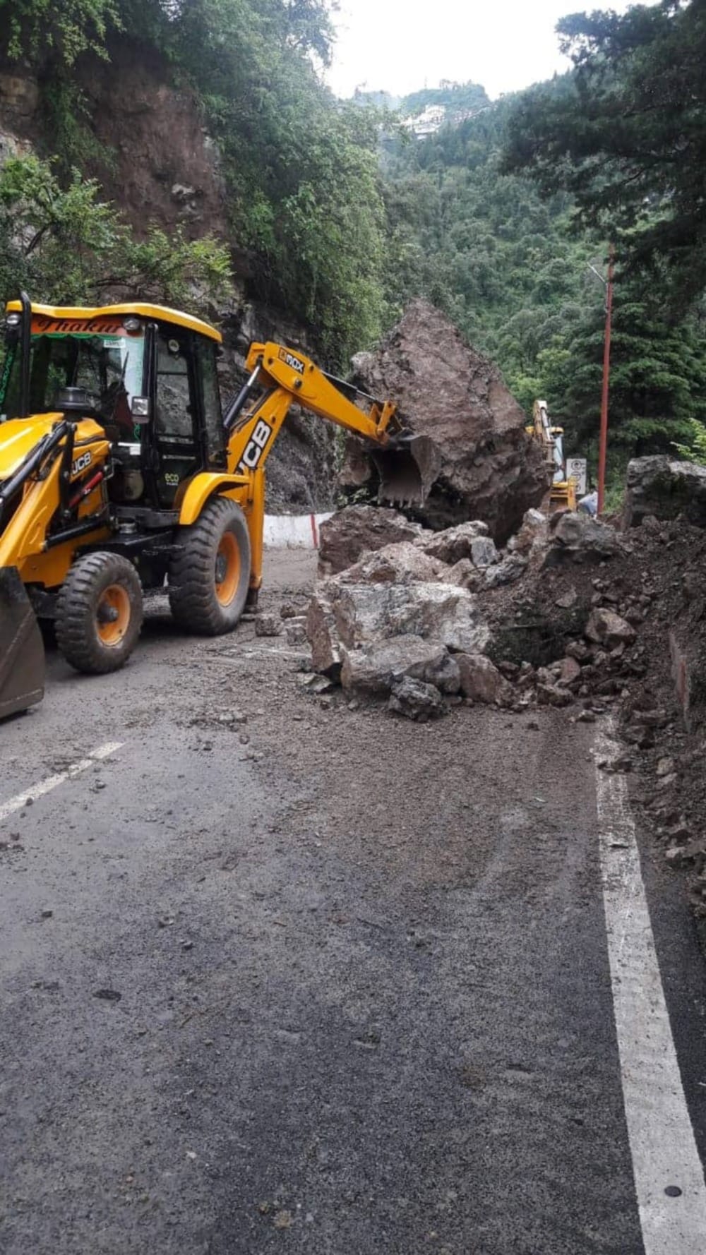 Heavy boulder fallen from the hill on the Mussoorie-Dehradun route