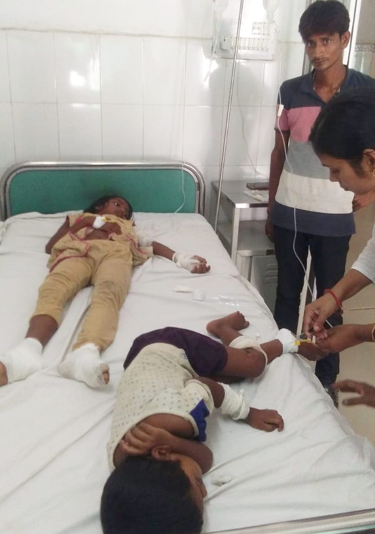 Broken electric wire, two kids swell
