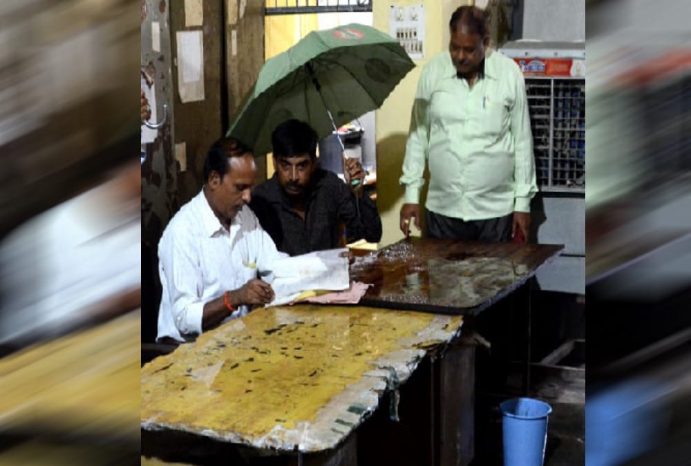 Haridwar nagar nigam Employees Doing work under umbrella after roof drop in rain