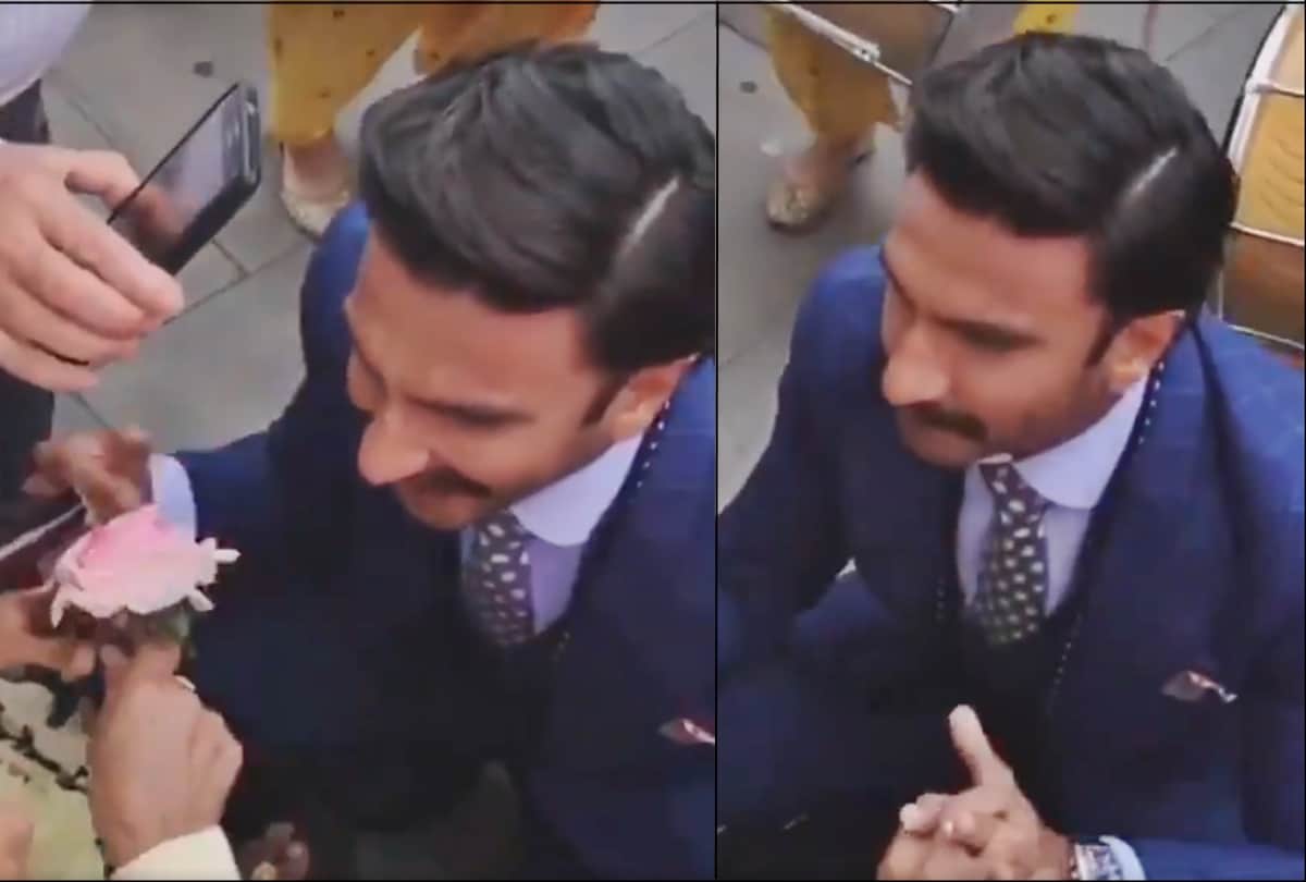 Ranveer Singh on his knees offering a rose to an old lady in a wheelchair in london