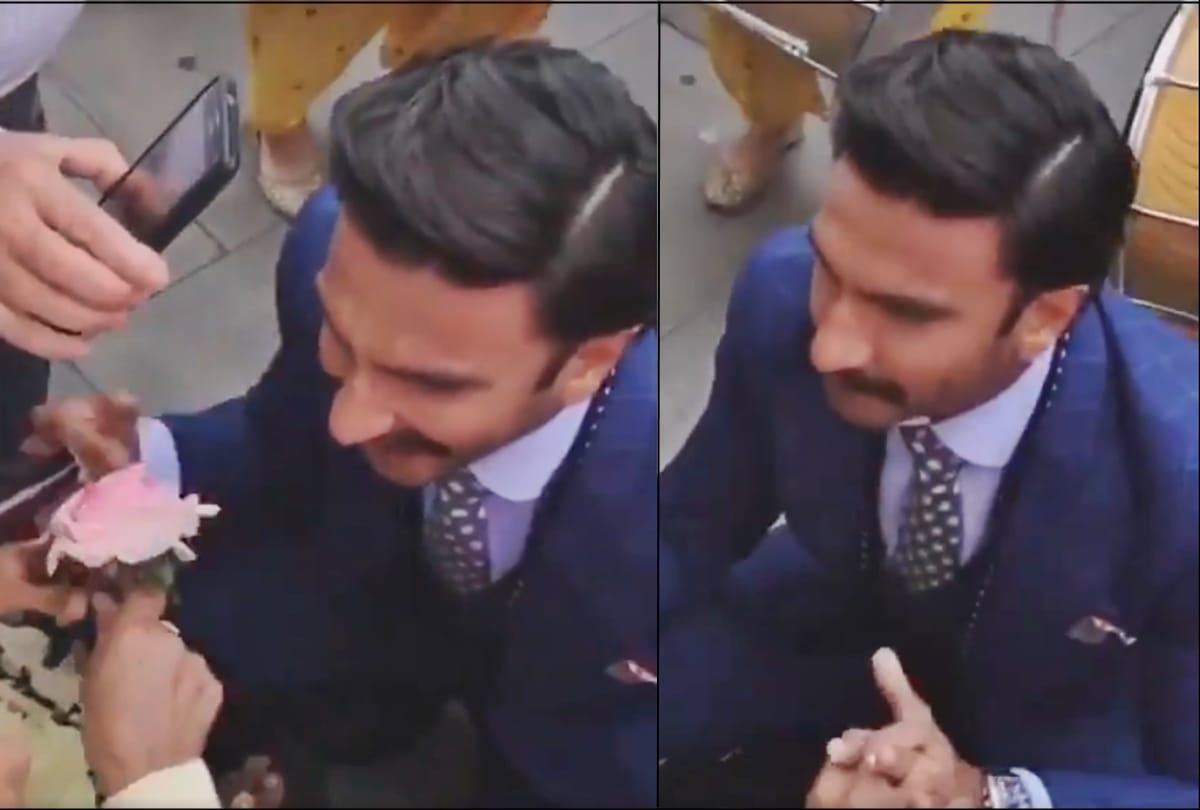 Ranveer Singh on his knees offering a rose to an old lady in a wheelchair in london