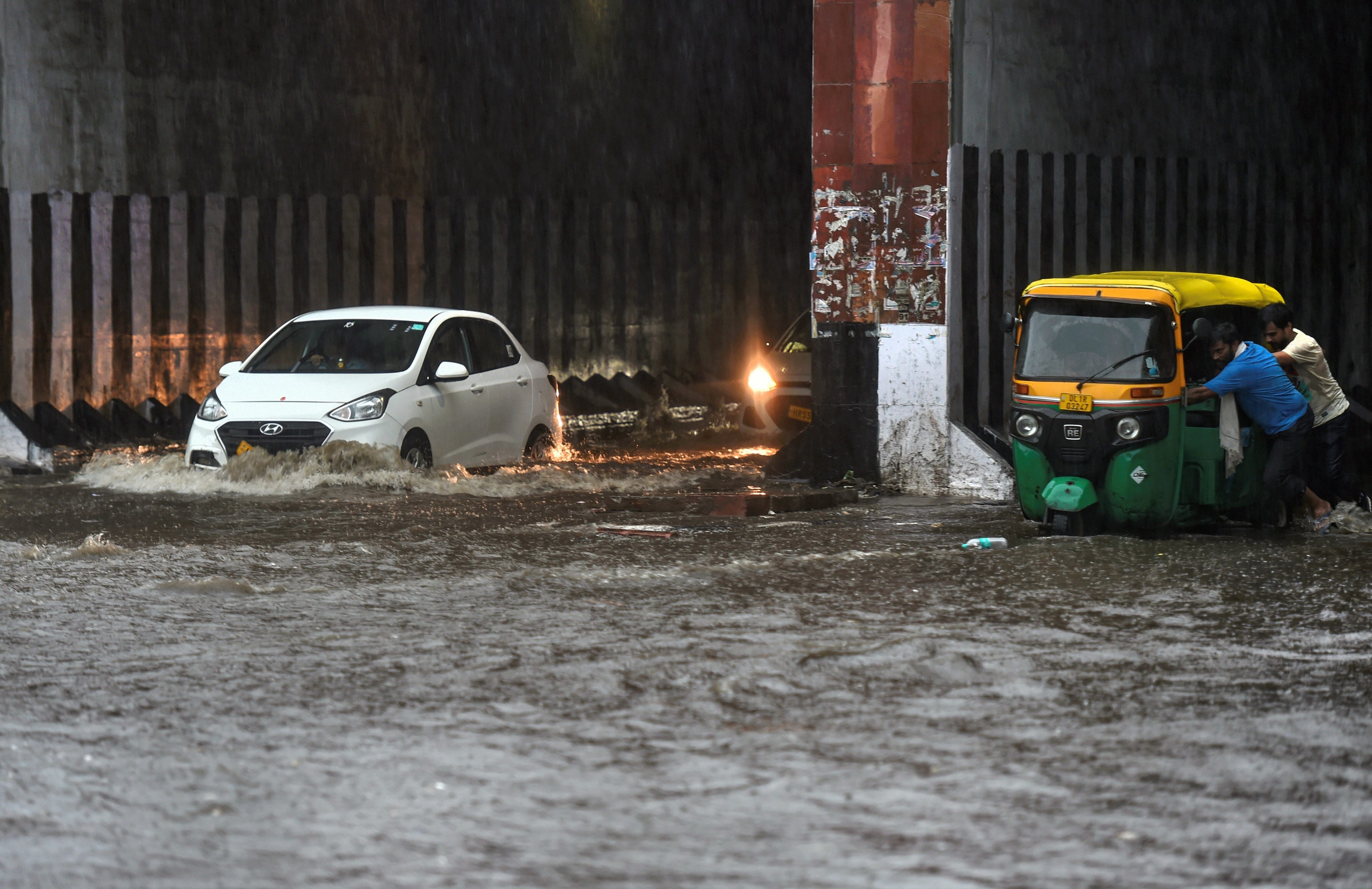 delhi ncr - heavy rains gives people relief, waterlogging outside parliament