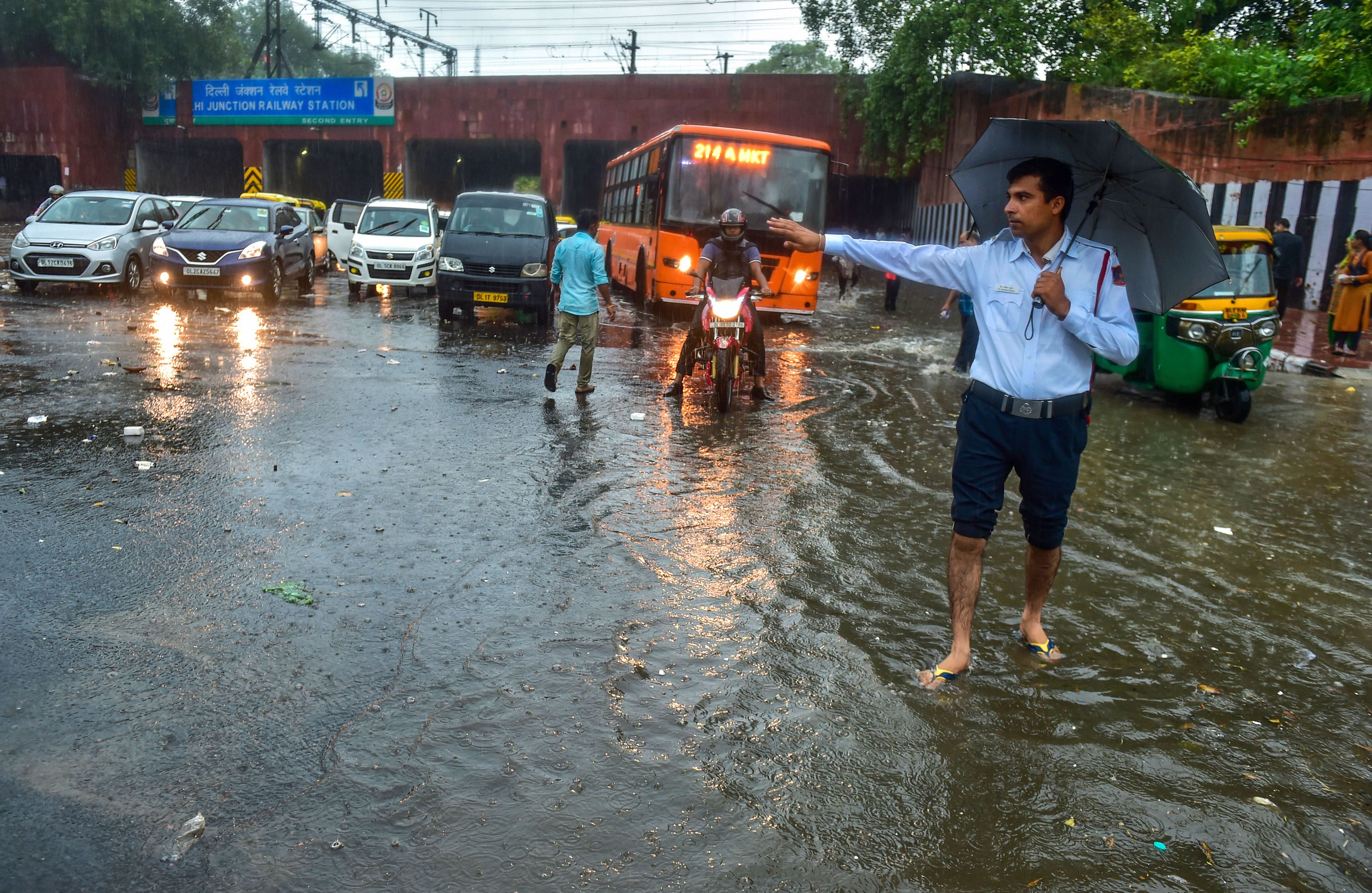 delhi ncr - heavy rains gives people relief, waterlogging outside parliament