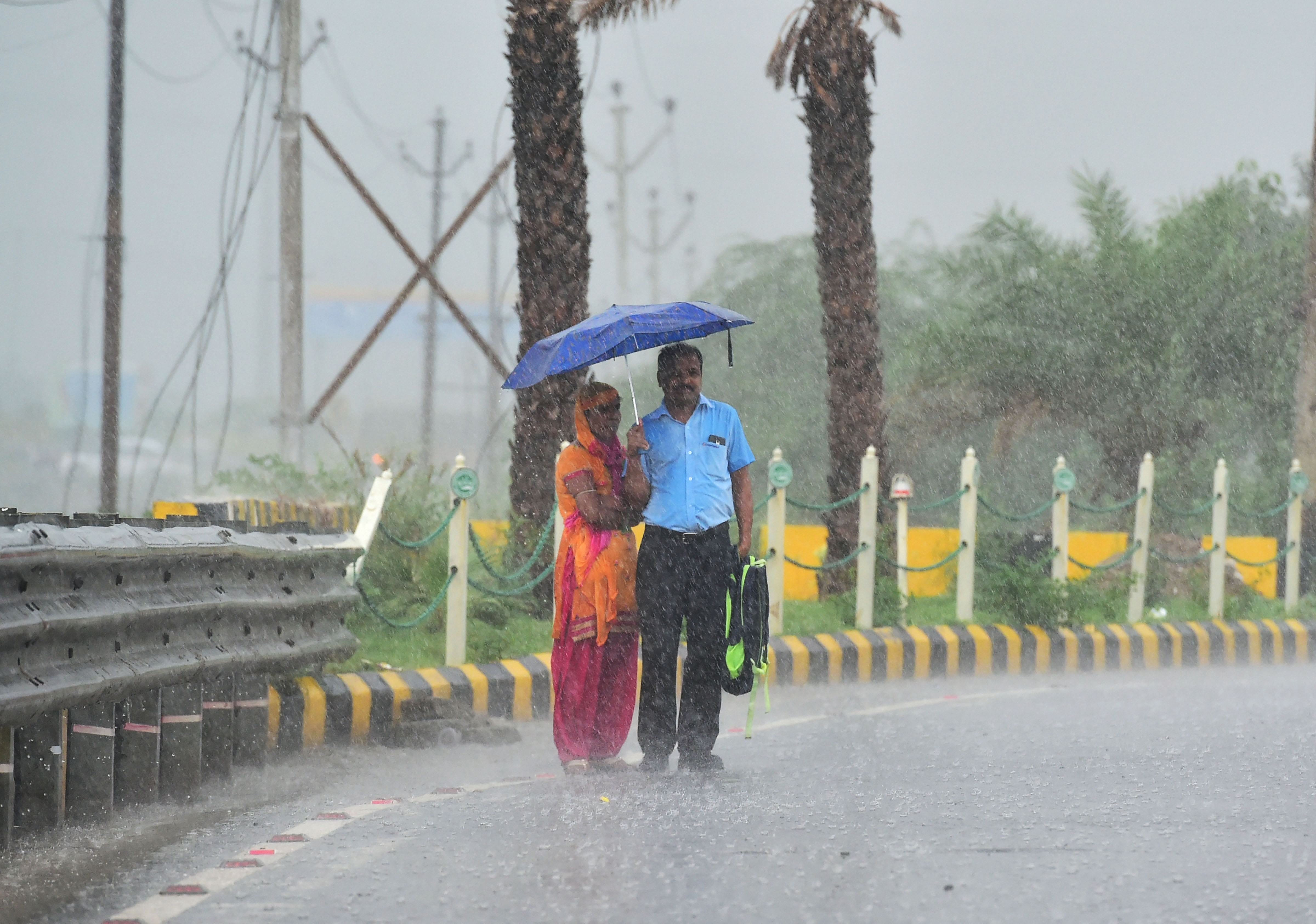 delhi ncr - heavy rains gives people relief, waterlogging outside parliament