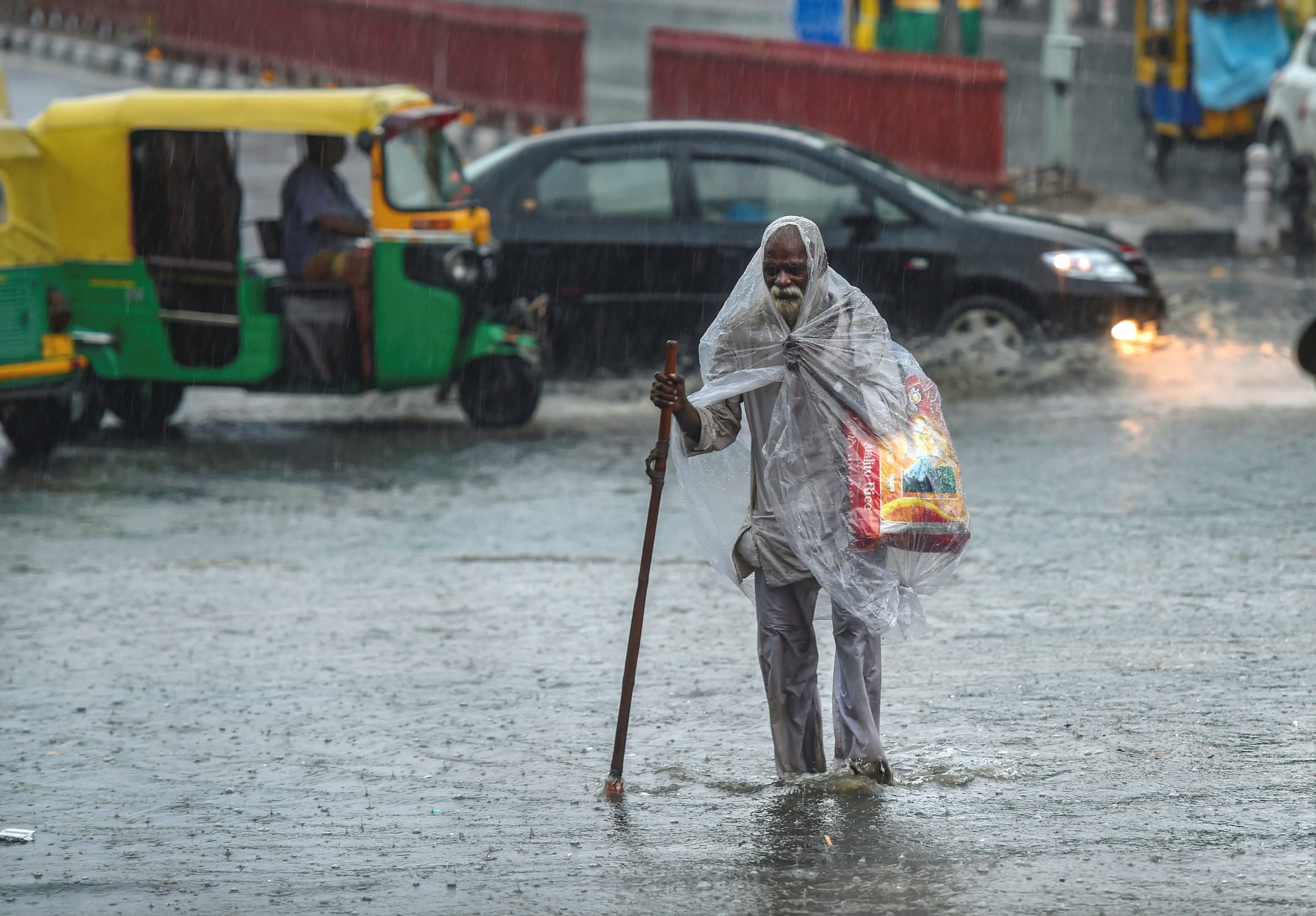 delhi ncr - heavy rains gives people relief, waterlogging outside parliament