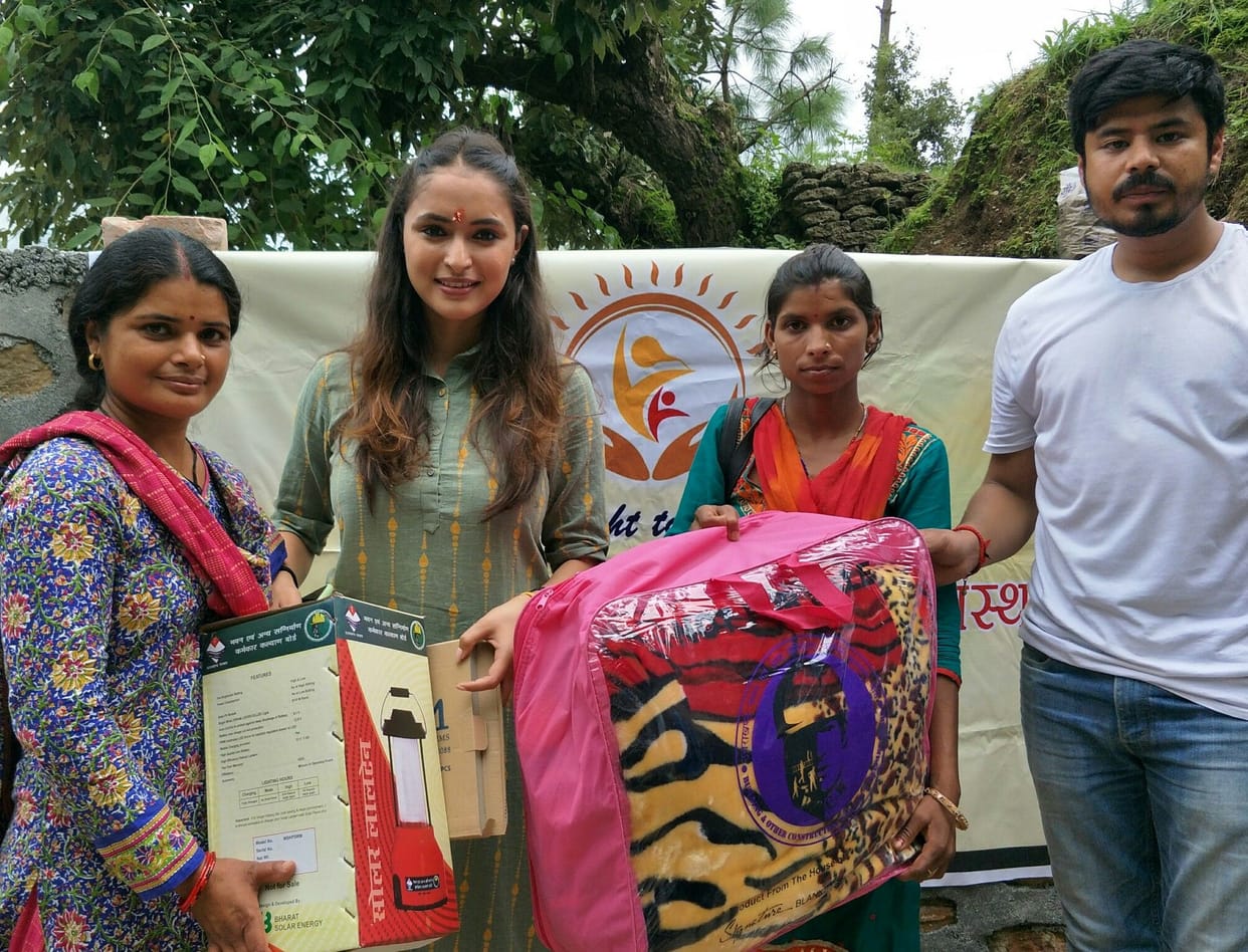 Sewing machines, blankets, umbrellas distributed to women