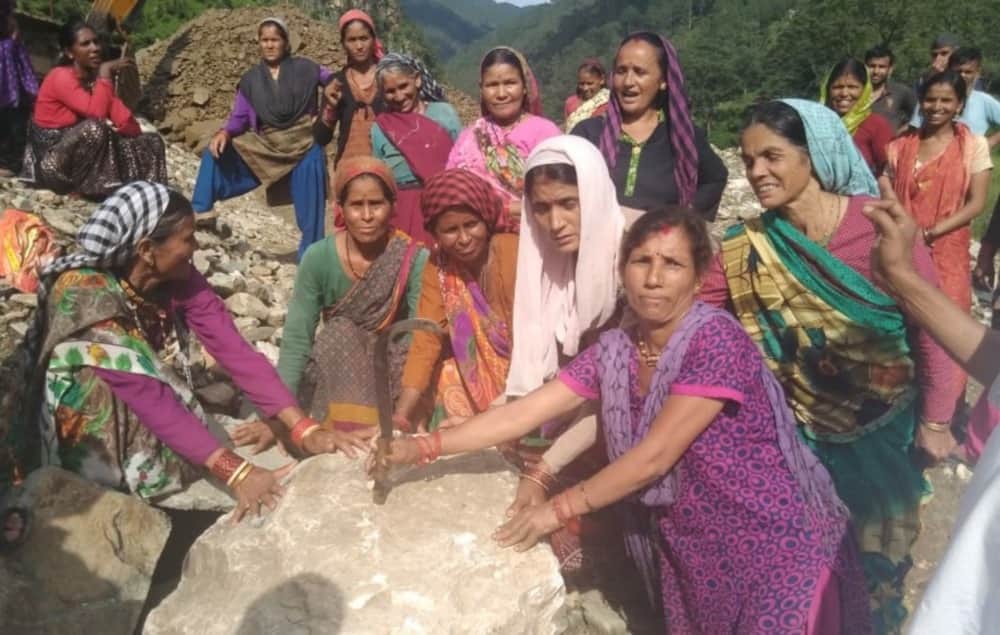 Women stand against mining reminding Chipko movement