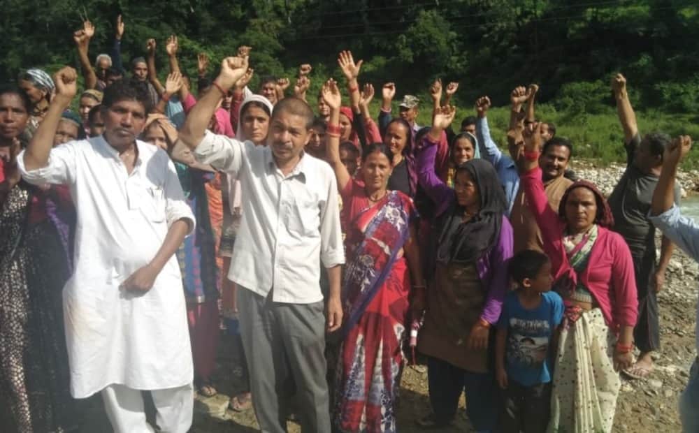 Women stand against mining reminding Chipko movement