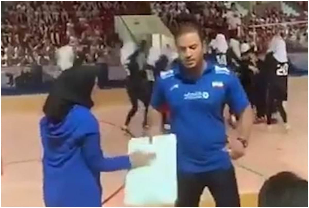 Iran Womens Volleyball players shakes hand with clipboard