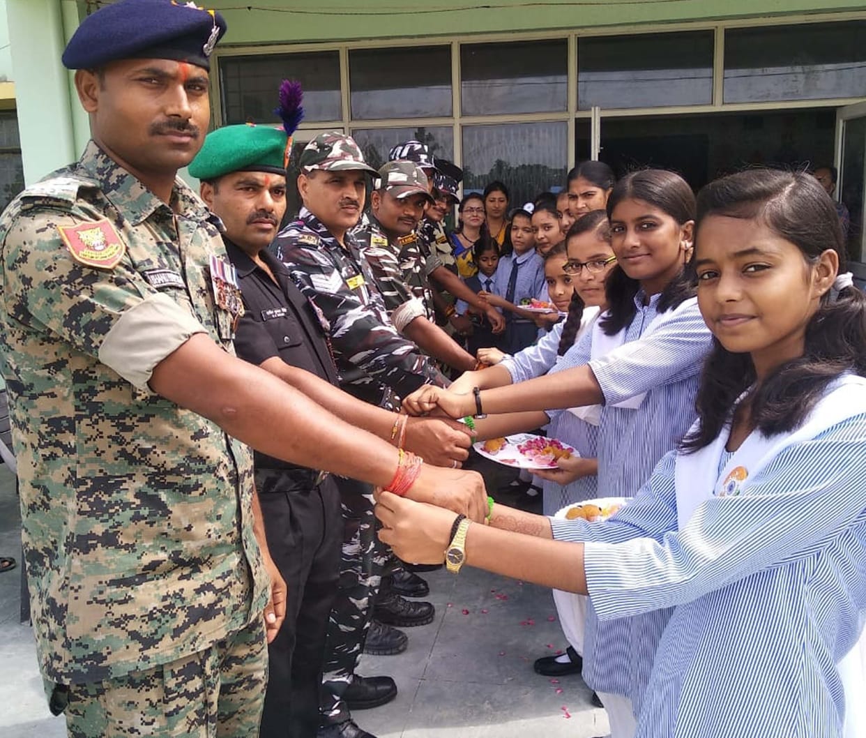 Sisters decorated brother's wrist with rakhi