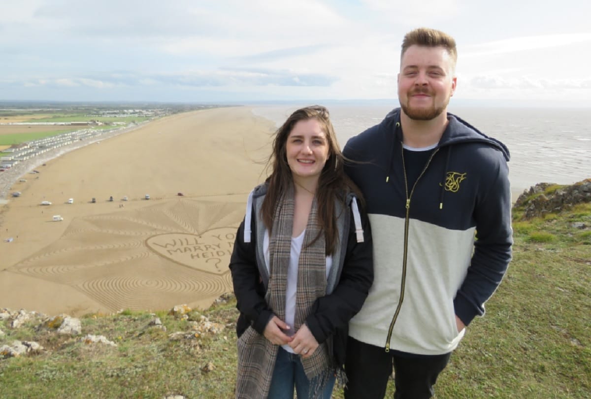 Unique marriage proposal Man propose his girlfriend at a beach by creating sand art